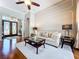 Elegant living room with hardwood floors, stylish furniture, and decorative wall moldings at 6924 Cumberland Ter, University Park, FL 34201