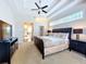 Bright main bedroom suite boasts a tray ceiling, fan, and ensuite bath for a luxurious private space at 6924 Cumberland Ter, University Park, FL 34201