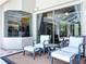 Relaxing outdoor seating area with comfortable chairs, complemented by a view of the enclosed pool area at 6924 Cumberland Ter, University Park, FL 34201