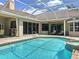 Sparkling pool and spa are encased in a screened lanai, creating a private outdoor entertainment space at 6924 Cumberland Ter, University Park, FL 34201