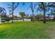 Spacious backyard features a detached garage and white fence at 7016 Dusty Rd, Riverview, FL 33569