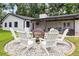 Backyard with fire pit area, patio under string lights, and ample yard space at 7016 Dusty Rd, Riverview, FL 33569