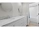 Bathroom with dual sinks, marble countertops, and modern fixtures at 7016 Dusty Rd, Riverview, FL 33569
