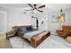Bedroom with a ceiling fan, leather chair, and attached bathroom at 7016 Dusty Rd, Riverview, FL 33569