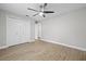 Bedroom with ceiling fan, laminate wood flooring and walk-in closet at 7016 Dusty Rd, Riverview, FL 33569