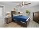 Cozy bedroom with wood furniture, ceiling fan, and plenty of natural light at 7016 Dusty Rd, Riverview, FL 33569