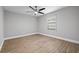 Empty bedroom with ceiling fan and laminate wood flooring at 7016 Dusty Rd, Riverview, FL 33569