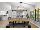 Elegant dining room with custom table and chairs, chic light fixture, and decorative barn doors at 7016 Dusty Rd, Riverview, FL 33569