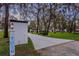 Long driveway leading to a charming home nestled among mature trees and manicured landscaping at 7016 Dusty Rd, Riverview, FL 33569