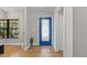 Light-filled foyer showcasing the decorative front door, wood floors, and fresh, neutral paint at 7016 Dusty Rd, Riverview, FL 33569