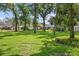 A lovely house featuring a spacious front yard with mature trees enhancing the property's curb appeal at 7016 Dusty Rd, Riverview, FL 33569