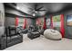 Luxurious home theater featuring reclining seats, a projector screen, and ambient lighting at 7016 Dusty Rd, Riverview, FL 33569