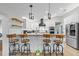 Modern kitchen with stainless steel appliances, barstool seating, and white cabinetry at 7016 Dusty Rd, Riverview, FL 33569