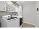 Laundry room with modern appliances, white cabinets, and practical design at 7016 Dusty Rd, Riverview, FL 33569