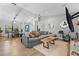 Open-concept living area with wood floors, comfortable furniture, and stylish decorations at 7016 Dusty Rd, Riverview, FL 33569