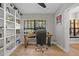 Cozy office with custom shelves, computer, and a comfortable chair at 7016 Dusty Rd, Riverview, FL 33569