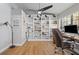 Home office with built in shelves, hardwood floors, and natural light at 7016 Dusty Rd, Riverview, FL 33569