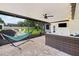 Spacious screened patio features a lounge area and open view of the backyard at 7016 Dusty Rd, Riverview, FL 33569