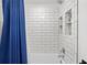 Bathroom shower with white subway tile and inset shelving at 7016 Dusty Rd, Riverview, FL 33569