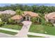 Stunning home with a paver driveway, well-manicured lawn, and lush landscaping creating curb appeal at 7659 Trillium Blvd, Sarasota, FL 34241