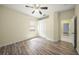 Bedroom featuring hardwood floors, double closets, neutral paint, and a ceiling fan at 7659 Trillium Blvd, Sarasota, FL 34241