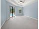 Bedroom with carpet and sliding glass doors that lead to the pool at 7659 Trillium Blvd, Sarasota, FL 34241