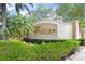 Entrance sign to 'Trillium, A Gathering Community', set among mature trees and lush landscaping, welcoming residents at 7659 Trillium Blvd, Sarasota, FL 34241