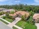 A stunning aerial view of a well-maintained single-Gathering home with lush green landscaping in a suburban community at 7659 Trillium Blvd, Sarasota, FL 34241