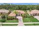 Beautiful single-story home featuring lush landscaping, a brick-paved walkway, and a tile roof at 7659 Trillium Blvd, Sarasota, FL 34241