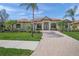 Charming single-story home boasting a brick-paved walkway and meticulous landscaping at 7659 Trillium Blvd, Sarasota, FL 34241