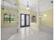 An open foyer boasts tile flooring, columns, and grand entryway doors at 7659 Trillium Blvd, Sarasota, FL 34241