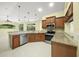 Kitchen with wood cabinets, granite countertops, and stainless steel appliances at 7659 Trillium Blvd, Sarasota, FL 34241