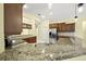 Granite countertops highlight this kitchen with a breakfast bar and stainless steel appliances at 7659 Trillium Blvd, Sarasota, FL 34241