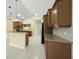 Open kitchen featuring wooden cabinets, granite counters, and modern appliances at 7659 Trillium Blvd, Sarasota, FL 34241