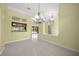 An expansive living area featuring tile flooring and a view of the outdoor pool at 7659 Trillium Blvd, Sarasota, FL 34241
