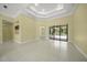 Open living room with tile floors and sliders leading to a pool view at 7659 Trillium Blvd, Sarasota, FL 34241