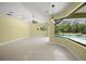 Living room with large window and sliding glass door overlooking the pool at 7659 Trillium Blvd, Sarasota, FL 34241