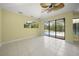 Bright living room with tile flooring and sliding door access to the pool area at 7659 Trillium Blvd, Sarasota, FL 34241