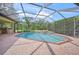 Refreshing screened-in pool and spa, complete with an outdoor grilling area at 7659 Trillium Blvd, Sarasota, FL 34241