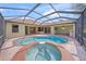 A luxurious pool and spa are the focal point of this private, screened outdoor living space with a beautiful brick patio at 7659 Trillium Blvd, Sarasota, FL 34241