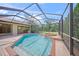 A private screened pool and spa offer a relaxing retreat with lush landscaping and serene outdoor ambiance at 7659 Trillium Blvd, Sarasota, FL 34241