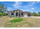 Single-story home featuring a landscaped front yard, arched entrance, and neutral color scheme at 8123 Wawana Rd, North Port, FL 34287