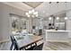 Open-concept kitchen featuring stainless appliances, a breakfast bar, and an adjacent dining area at 8123 Wawana Rd, North Port, FL 34287