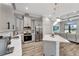This kitchen boasts stainless steel appliances, a quartz countertop island, and gray cabinets at 8123 Wawana Rd, North Port, FL 34287