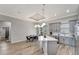 Bright, open kitchen features gray cabinets, an island with quartz countertops, and wood-look tile flooring at 8123 Wawana Rd, North Port, FL 34287