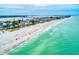 Stunning aerial view of the coastline showcasing pristine beaches and beautiful waterfront homes at 8420 43Rd Avenue W Dr, Bradenton, FL 34209