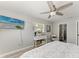 Comfortable bedroom with a television, a reading chair, and a view from the window at 8420 43Rd Avenue W Dr, Bradenton, FL 34209