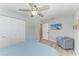 Bright bedroom with a ceiling fan, light gray walls, and wood-look flooring at 8420 43Rd Avenue W Dr, Bradenton, FL 34209