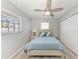 Bedroom with a ceiling fan, light gray walls, and wood-look flooring, closet, and window at 8420 43Rd Avenue W Dr, Bradenton, FL 34209