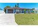 Charming single-story home featuring a well-manicured lawn and an attached garage at 8420 43Rd Avenue W Dr, Bradenton, FL 34209